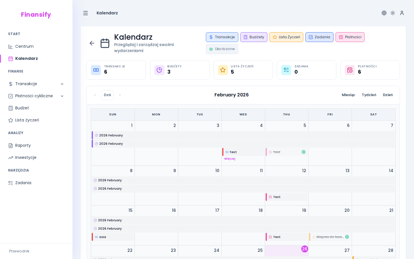 Widok miesięczny kalendarza — kolorowe znaczniki na różnych dniach, legenda kolorów na dole/boku